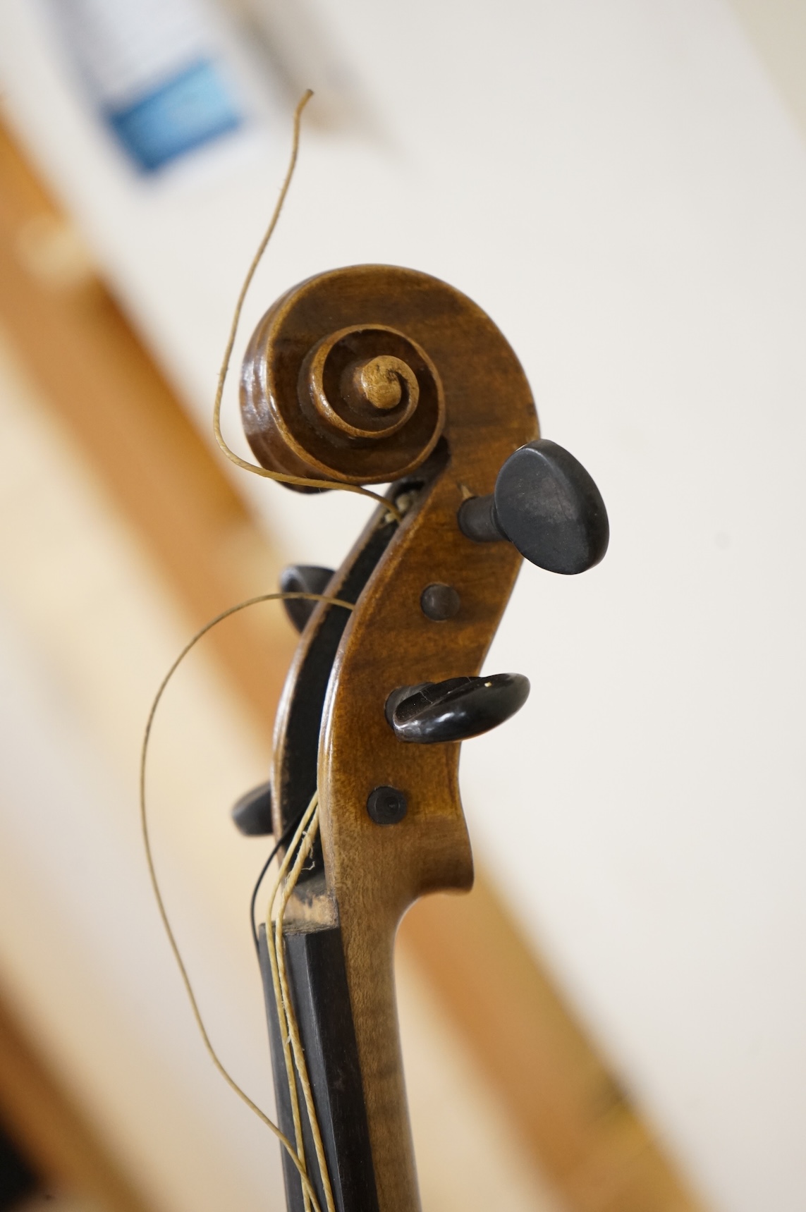 Three cased violins; a German Dresden violin, supplied by Campbell and co., Glasgow, together with another Dresden Stradivarius copy, and the remains of a European violin.